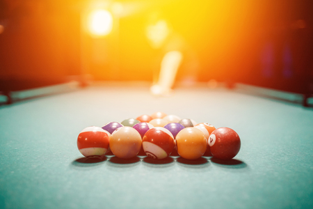 Balls for billiards snooker are triangle, man smashes cueの写真素材
