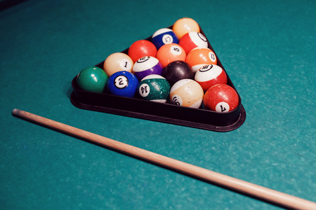 Balls for billiards pool snooker are on green table, preparation for gameの写真素材
