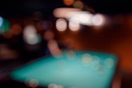 Blurred background men play snooker billiards on table ballsの写真素材