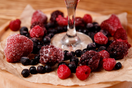 Refreshing cocktail with raspberries and alcohol, red. Decorated with fresh forest berries.の写真素材