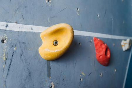 Close-up of hooks for rock climber on wall. Multicolored background.の写真素材