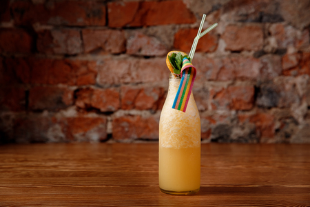 Useful smoothies from fresh berries of yellow color with orange and lemon.の写真素材
