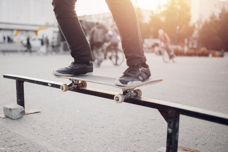 Male skateboarder performs tricks on ramp on skateboard. Concept street sports, bullyの写真素材