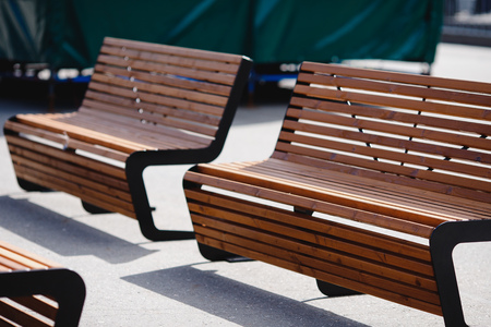 Modern wooden benches for relaxing in park, close-upの写真素材