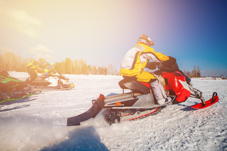 Snowmobile races start in snow. Concept winter sportsの写真素材