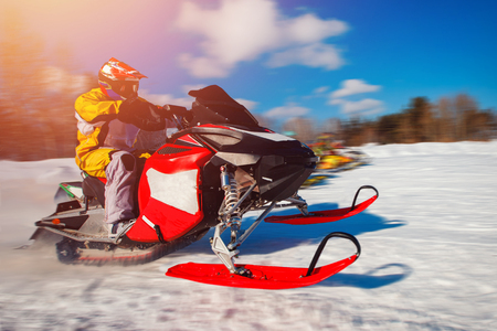 Snowmobile races start in snow. Concept winter sportsの写真素材