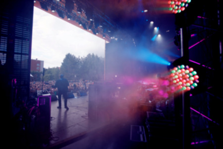 Blurred concert background crowd of people, stage and lighting equipment.の写真素材