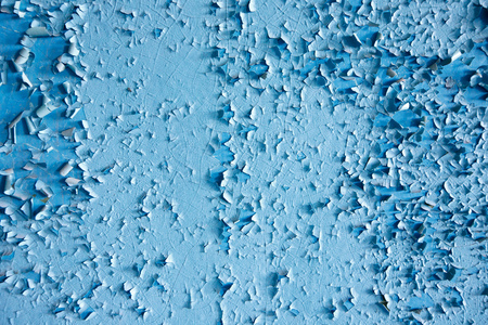 Texture paint old, peeled off pieces from wall, blue background. Concept solar radiation, corrosion.の写真素材
