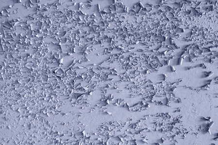 Texture paint old, peeled off pieces from wall, blue background. Concept solar radiation, corrosion.の写真素材