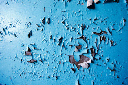 Texture paint old, peeled off pieces from wall, blue background. Concept solar radiation, corrosion.の写真素材
