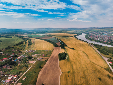 Field in farm is sown with barley, buckwheat, wheat, plowed land for planting crop. Aerial photography, top view.の写真素材