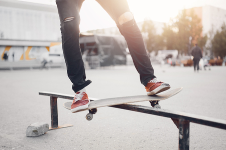 Male skateboarder performs tricks on ramp on skateboard. Concept street sports, bullyの写真素材