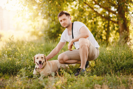 Man owner caressing gently her labrador dog. Concept friendshipの写真素材