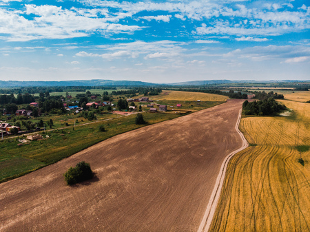 Field in farm is sown with barley, buckwheat, wheat, plowed land for planting crop. Aerial photography, top view.の写真素材