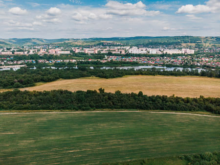 Field in farm is sown with barley, buckwheat, wheat, plowed land for planting crop. Aerial photography, top view.の写真素材