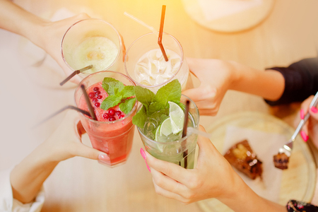 Cheers group of women met with friends and drink cocktails. Concept meetingの写真素材