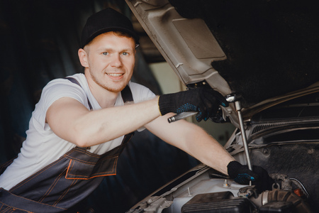 Mechanic working in auto repair service carの写真素材
