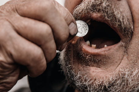 Concept Pension of Russia. Dirty hands old man poor with coin ruble.の写真素材