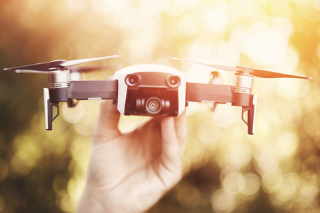 Drone quadrocopter takes off from man hand in park. Technology concept of blogger photographer.の写真素材