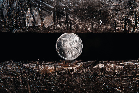 Ruble iron coin is clamped in vice. Concept of sanctions against Russia.の写真素材
