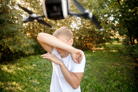 Drone fighter attacks man in park. Concept loss of control over aircraft.の写真素材