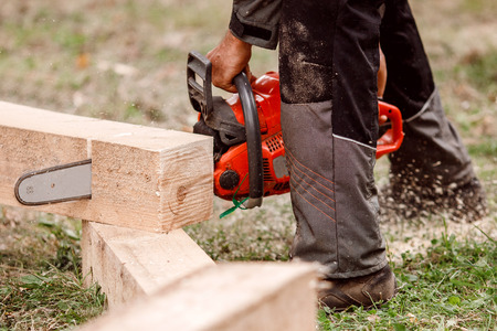 Close-up of woodcutter lumberjack is man chainsaw tree.の写真素材