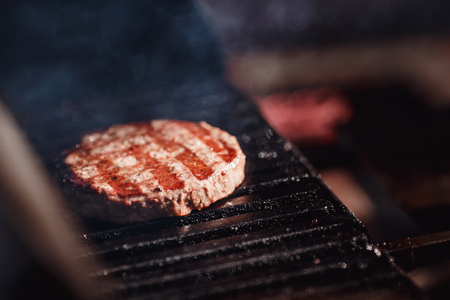 Close-up grill cook fresh burger hamburger cutlets from meat beefの写真素材