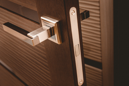 Metal handle on open Door modern brown.の写真素材
