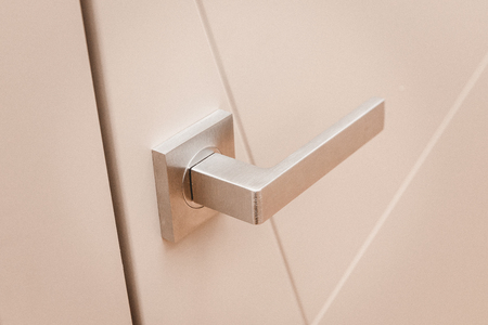 Part metal handle on modern interior door.の写真素材