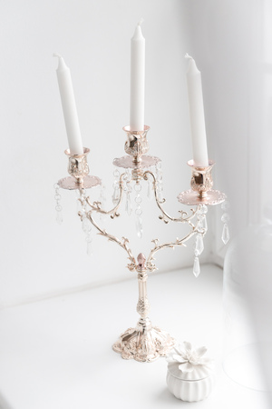 Modern antique candlestick with wax candles in classic style, white colorの写真素材