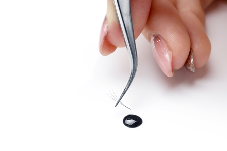 Closeup eyelash extension tools on white background. Artificial lashes 3D, classic drop of glue isolated.の写真素材