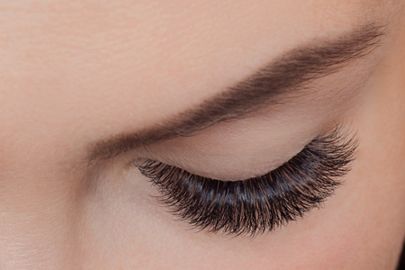 Concept eyelash extension procedure. Woman with long lashes in beauty salon. Top viewの写真素材