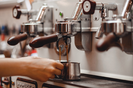 Coffee extraction espresso from professional machine and barista with filterの写真素材