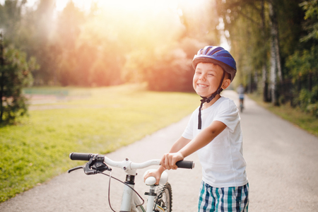 Little boy in helmet learning to ride bicycle park having funの写真素材