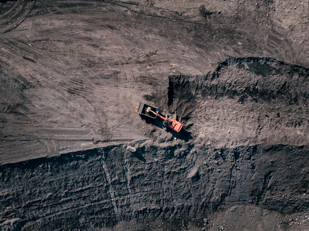 Open pit mine, extractive industry for coal, top view aerial drone. Excavator at work.の写真素材