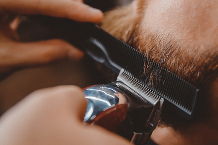 Man hipster having barber shave barbershop hair machine.の写真素材