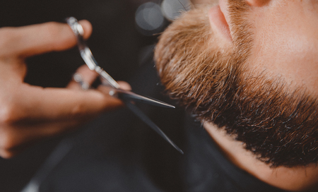 Man hipster having barber shave the barbershop.の写真素材