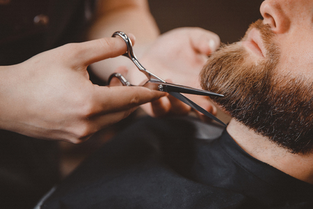 Barber beard styling and cut process. Barbershop for men.の写真素材