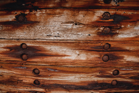 Background is old dark wooden from ship and rusty nails.の写真素材