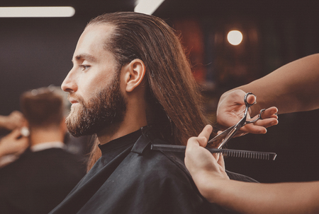 Process of cutting hair with scissors, hairdresser for men.の写真素材