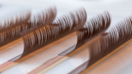Eyelash brown extension procedure. Set Lashes close up pink comb