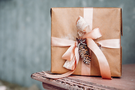 Gift for girl new year in kraft paper, pink ribbon, lump.の写真素材