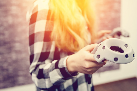 VR girl is holding a virtual reality joystick. The concept of the game in reality.high contrast and monochrome color toneの写真素材
