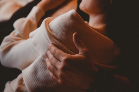 Couple man and girl lying in clothes pants blue on the bed, legs touching each otherの写真素材