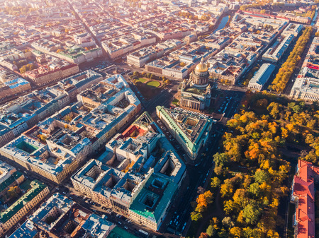 Saint-Petersburg. Autumn urban landscape. Colored roofs of houses and yellow crowns trees, bright Sunny day. Top view aerial droneの写真素材