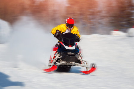 Snowmobile races jump in snow. Concept winter sports.