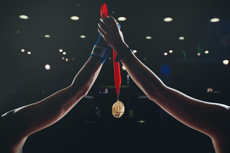 Winner boxer mma holds gloves gold medal first place in fight competitionsの写真素材