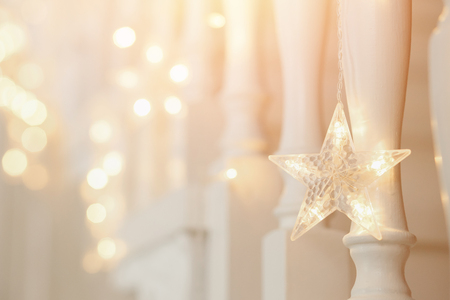 New Year decorations for Christmas stars with light, blurred background.の写真素材
