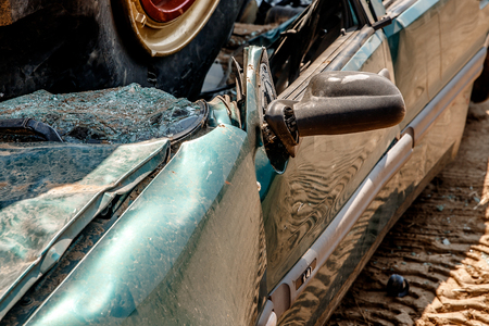 Broken car after an accident on highway, big collision road autobahn. Concept auto recycling.の写真素材