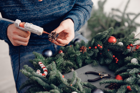 Christmas tree wreath decoration with man hand workshop DIY.の写真素材